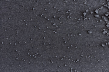 Fototapeta na wymiar Frosty pattern on glass with a dark background