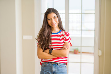 Young beautiful woman wearing casual t-shirt happy face smiling with crossed arms looking at the camera. Positive person.