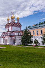 Fototapeta na wymiar Entrance gate to the monastery, side view. Vertical orientation. Russian shrines. Joseph-Volotsky Monastery in Teryaev. Moscow region, Teryaevo.