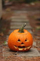 halloween jack o' lantern outside on a path