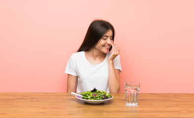 Obraz na płótnie Canvas Young woman with a salad smiling a lot