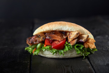 close up of kebab sandwich on wooden background