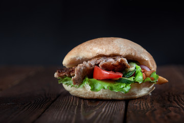 close up of kebab sandwich on wooden background