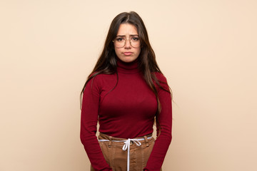 Teenager girl with glasses with sad and depressed expression