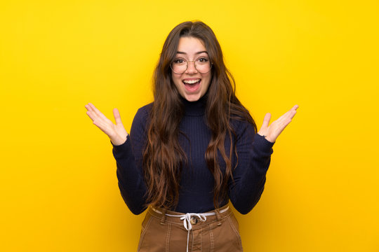 Teenager Girl Over Isolated Yellow Wall With Shocked Facial Expression