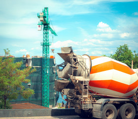 tower crane and mixer truck working at construction site