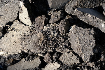  Old road surface. Pieces of asphalt