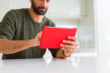 Close up of man using touchpad tablet and smiling