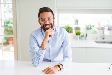 Handsome business man wearing glasses and smiling cheerful with confident smile on face