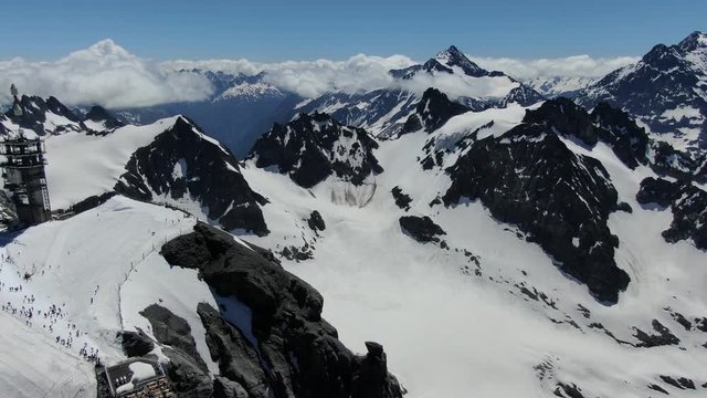 Drone view to snow Alps mountains around Titlis mountain in Switzerland. Shot was made in June.