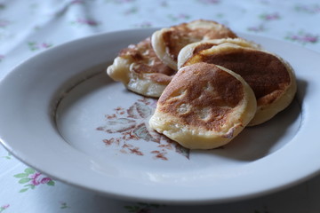 A few pancakes  lie on a plate