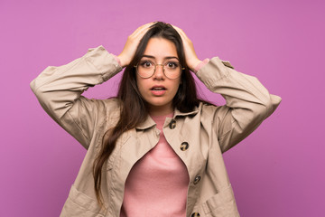 Teenager girl over purple wall with surprise facial expression