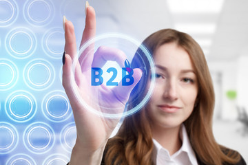 The concept of business, technology, the Internet and the network. A young entrepreneur working on a virtual screen of the future and sees the inscription: B2B