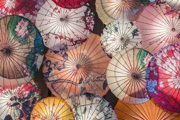 Many traditional Chinese oil paper umbrellas under the light