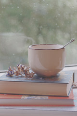 cup of tea ob the pile of books