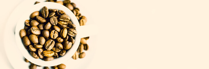 Coffee beans in espresso cuo. Concept of coffee drink, perk, morning and coffee shop. Close up. Selective focus. Copy space.