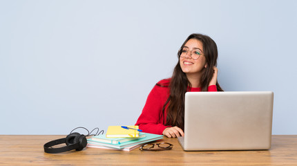 Teenager student girl studying in a table thinking an idea