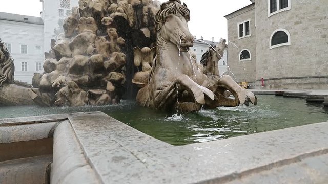 Fountain with lion sculpture in the center of Salzburg in Austria. Filmed in slow motion.