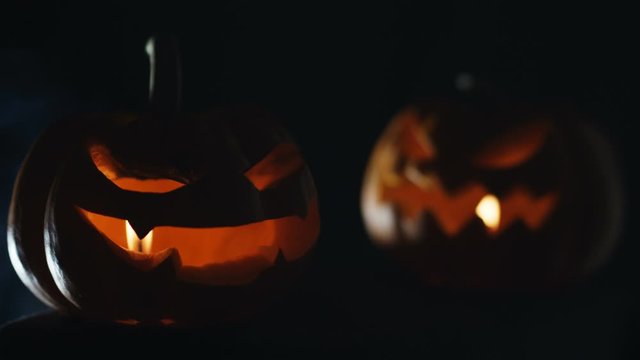 Pumpkins Jack o lantern face with lights and smoke for Halloween night.