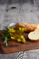 bowl of olive oil with rosemary herb and bread