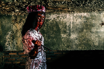 Horror of ghost nurse woman or zombie held the knife. In of the abandoned hospital.