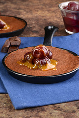 pan of chocolate cake with cherry topping