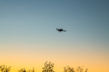 The drone is flying around to taking pictures of high angle with sunset sky.
