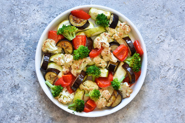 Many different vegetables and spices baked in the oven. View from above.