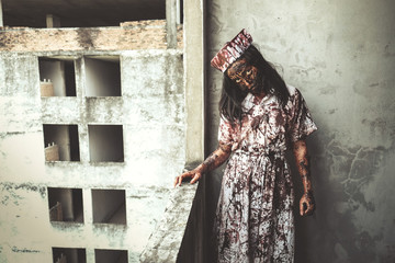 Horror of ghost nurse woman or zombie held the knife. In of the abandoned hospital.