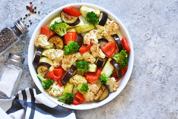 Many different vegetables and spices baked in the oven. View from above.
