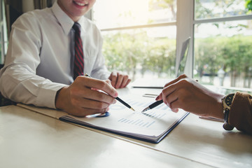 Hand of the businessman who is presenting information and analyzing the market.