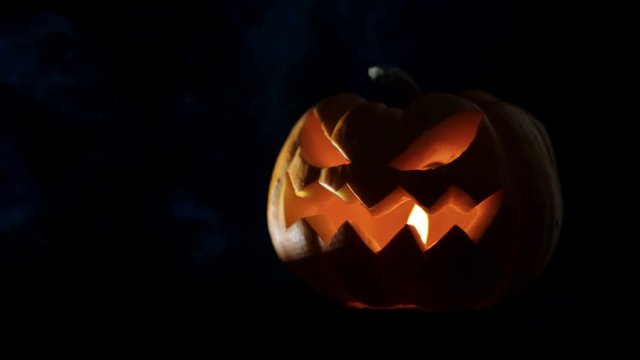 Halloween pumpkin Jack o lantern with candle lights at night.