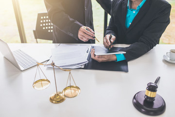 Businessmen and lawyer discuss lawsuits in the office.