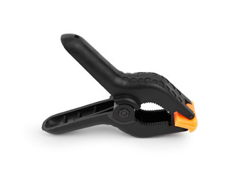 Spring clamp isolated on white background. Black plastic clamp. Set of small and big size. Clamping equipment for handicraft, joinery, photography, cars.