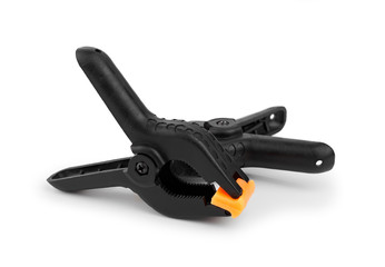 Obraz premium Spring clamp isolated on white background. Black plastic clamp. Set of small and big size. Clamping equipment for handicraft, joinery, photography, cars.