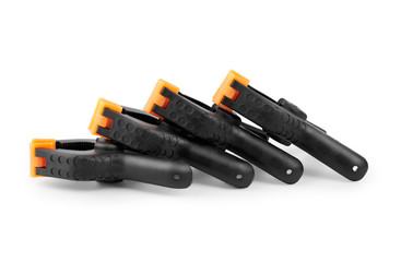 Spring clamp isolated on white background. Black plastic clamp. Set of small and big size. Clamping equipment for handicraft, joinery, photography, cars.