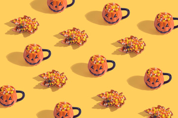 Halloween holiday creative background with jack o lantern pumpkin cup and candy corn