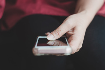 hipster woman using hands touching and typing on mobile phone screen search internet online working or social communication with digital 5G technology app device in coffee shop indoor lifestyle.