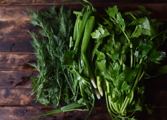 fresh herbs, onions, parsley, dill on the table