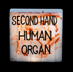 A cooling box with human organs for transplantation on black background. Illegal sale of human...