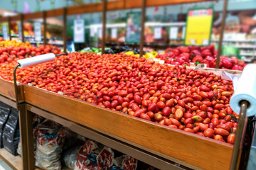 red cherry tomatoes, many on sale in the store on the counter in the supermarket. environmentally friendly product