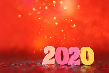 Holiday image of New Year 2020 concept. Wooden number and sparkling background