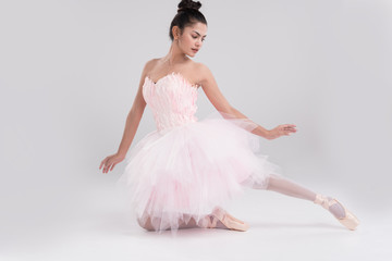 Fototapeta premium Beautiful young woman ballerina show ballet dance,dress in fink feather,professional outfit,Beauty of classic ballet.