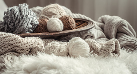 Obraz na płótnie Canvas Still life with a cozy variety of yarn for knitting.