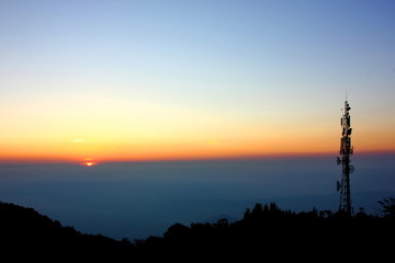 mobile station on mountain with sun set sky background
