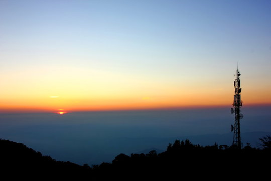 mobile station on mountain with sun set sky background