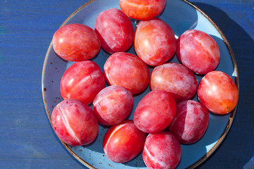 Sweet and juicy plums in bowl.