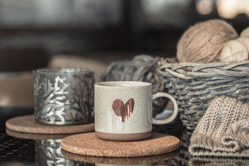 Cozy Autumn background with a beautiful Cup with a heart.