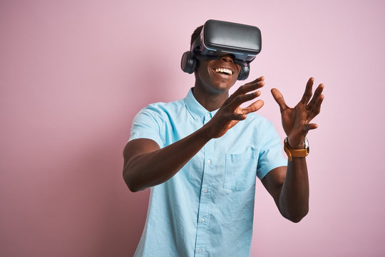 Young african american man playing virtual reality game using goggles