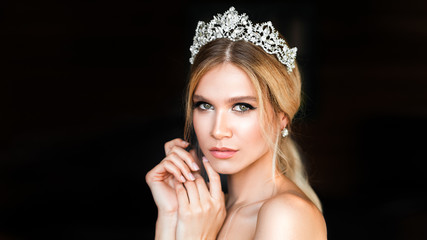 Sensual sexy woman in diadem over dark background. © Stavros